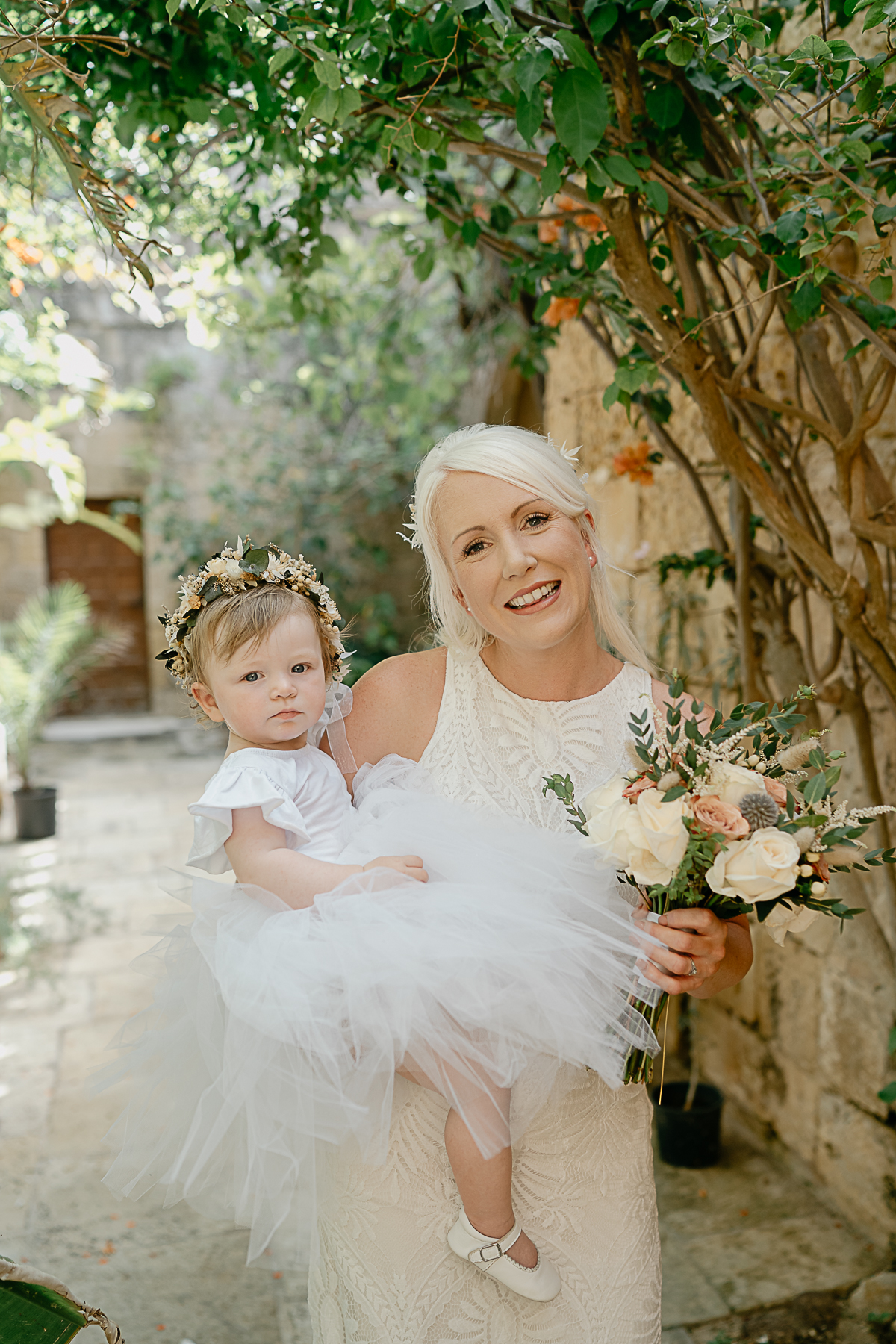 portrait of Bride and baby in Ta' Cenc Hotel wedding courtyard in Gozo